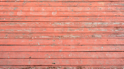 Old faded planked surface painted with red paint
