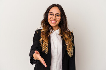 Young mexican business woman isolated on white background stretching hand at camera in greeting gesture. © Asier