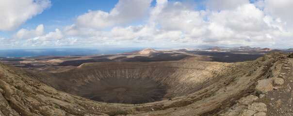 Volcano Panorama with a blue sky, extinct volcanic crater on Lanzarote, Spain. Beautiful Lanscpae Backgriund.