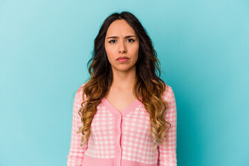 Fototapeta premium Young mexican woman isolated on blue background sad, serious face, feeling miserable and displeased.