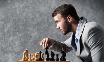 Businessman moving chess figure in chessboard