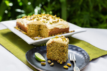 Lime and pistachio cake in garden setting