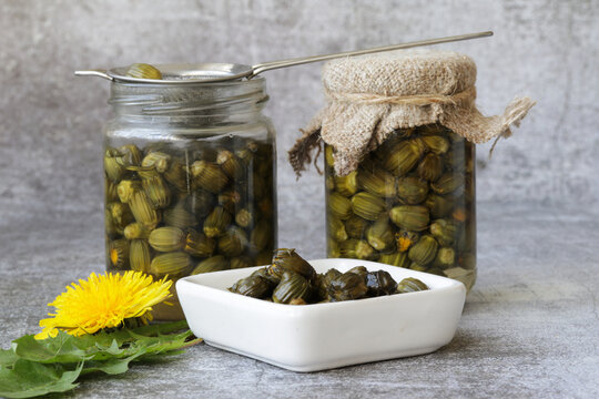 False capers made from ypung dandelion buds in glass jar.