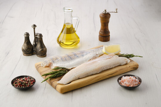 Raw zander fillet on wooden cutting board