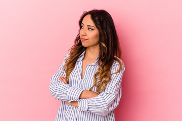 Young mexican woman isolated on pink background dreaming of achieving goals and purposes