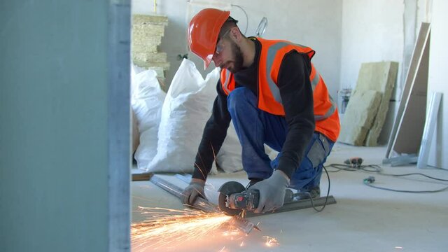 Male builder cutting metal detail during work