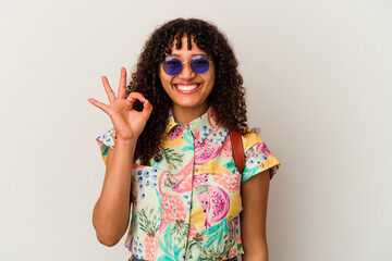 Young mixed race woman wearing sunglasses taking a vacation isolated cheerful and confident showing...