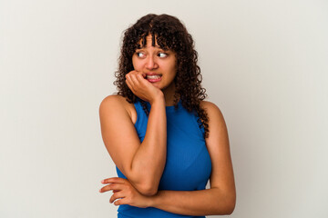 Young mixed race woman isolated on white background biting fingernails, nervous and very anxious.
