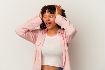 Young mixed race woman isolated on white background screaming, very excited, passionate, satisfied with something.