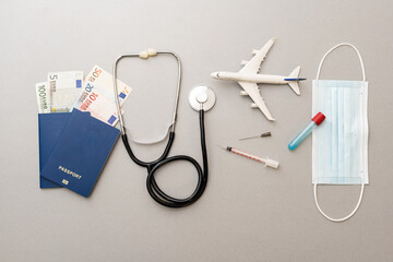 Passport, stethoscope and toy plane.