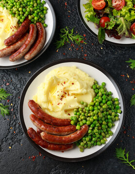 Pork Chipolata sausages with home cooked mashed potato and green peas