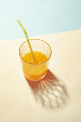 Orange juice in a glass and bright sunlight