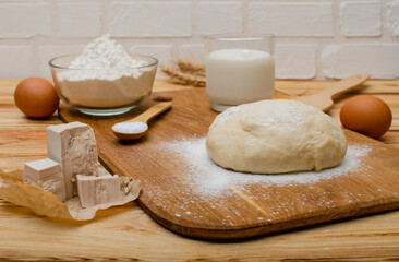 Fresh dough on the board and fresh yeast.