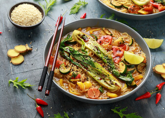 Asian style Pak choi, lemongrass, and ginger curried noodles served with lime wedges