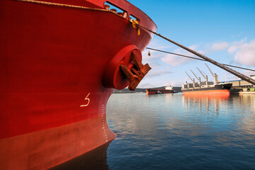 The bow of an industrial ship at the mooring wall in the seaport