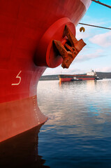 The bow of an industrial ship at the mooring wall in the seaport