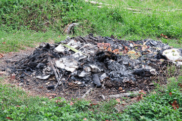 The remains of the garbage pile after the burn become ash.