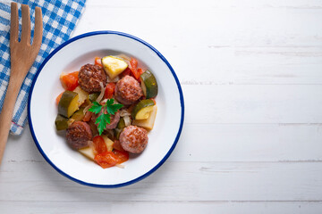 Meatballs with roasted vegetables. Traditional Spanish tapa.