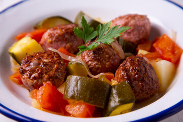 Meatballs with roasted vegetables. Traditional Spanish tapa.