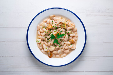 Beans with cod and pork belly. Traditional Spanish recipe.