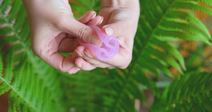 Close up of how to use menstrual cup .  Zero waste and eco friendly concept