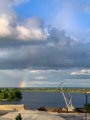 rainbow near the river and industrial with blue sky