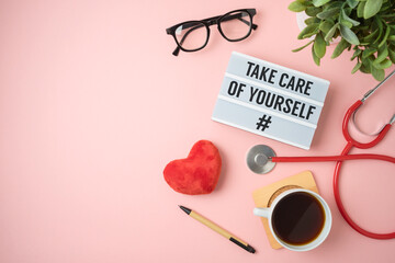Trendy self care concept with light box, heart shape and stethoscope on pink background
