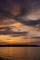 Obraz premium beautiful sunset over the river with orange colors