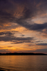 Naklejka na ściany i meble beautiful sunset over the river with orange colors