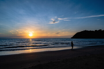 Silhouette people with Beautiful idyllic seascape sunset view on kohkood island in low season travel.Koh Kood, also known as Ko Kut, is an island in the Gulf of Thailand