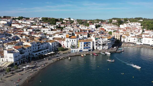 View from drone of small town Cadaques and many boats in bay, Costa Brava, Spain, famous tourist destination