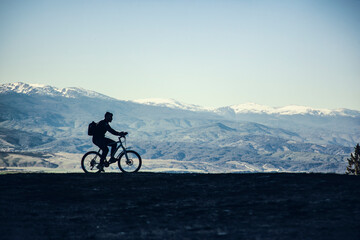 Fototapeta na wymiar Cyclist man on a background of mountains