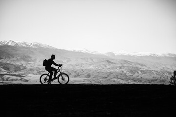 Fototapeta premium Cyclist man on a background of mountains