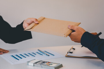 Businesswoman accountant is rejecting money in white envelope offered by his partner in the dark -...