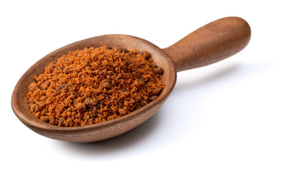 brown sugar in the wooden spoon, isolated on white background