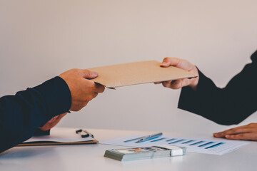 Businesswoman accountant is rejecting money in white envelope offered by his partner in the dark -...