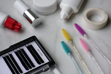 Lashmaker tools on white light background