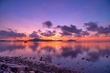 Beautiful light of nature landscape Sunset or sunrise Burning golden sky and shining golden waves Beautiful light reflection on sea surface Amazing landscape nature background
