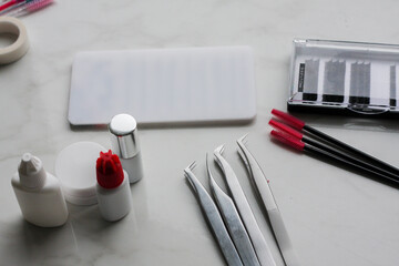 Lashmaker tools on white light background