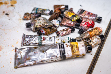 Old oil paint kit with attaché case. Various dirty oil paint tubes in a briefcase. Tidying,...