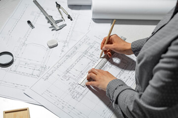 Architect designer draws a sketch of the project on white paper. Engineering blueprints.