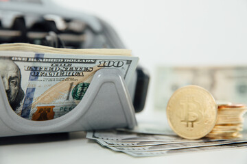 Close up of bitcoin crypto currency coins and american dollar banknotes. USA dollars. Money background. Crypto currency golden bitcoin coin