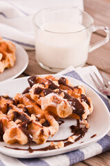 Obraz na płótnie Canvas Waffles with chocolate cream and hazelnuts.