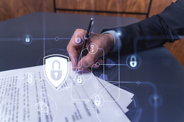A businessman in formal wear signing the contract to prevent probability of risks in cyber...