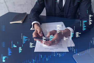 A client in formal wear reading the contract to invest money in stock market. Internet trading and...