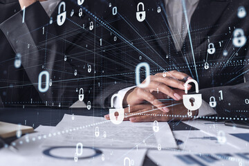 Two businesswomen working on the project to protect cyber security of international company. Padlock Hologram icons over the table with documents.