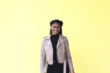 beautiful and happy african american woman, on a yellow background