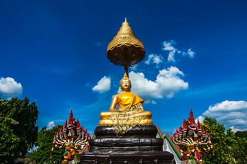 Naklejka premium The Gold meditation Buddha statue in the garden at Wat Amara wararam temple, Bangkok Thailand