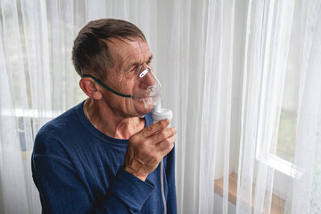 elderly senior with an oxygen mask in quarantine