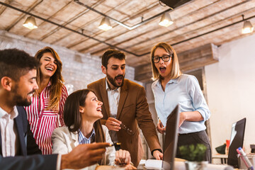 Business project team working together at meeting room at office using laptop.
